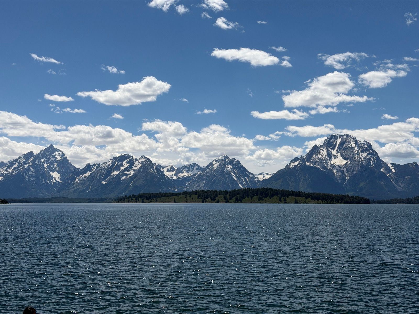 Blue lake stretching toward the snow-streaked Teton Range