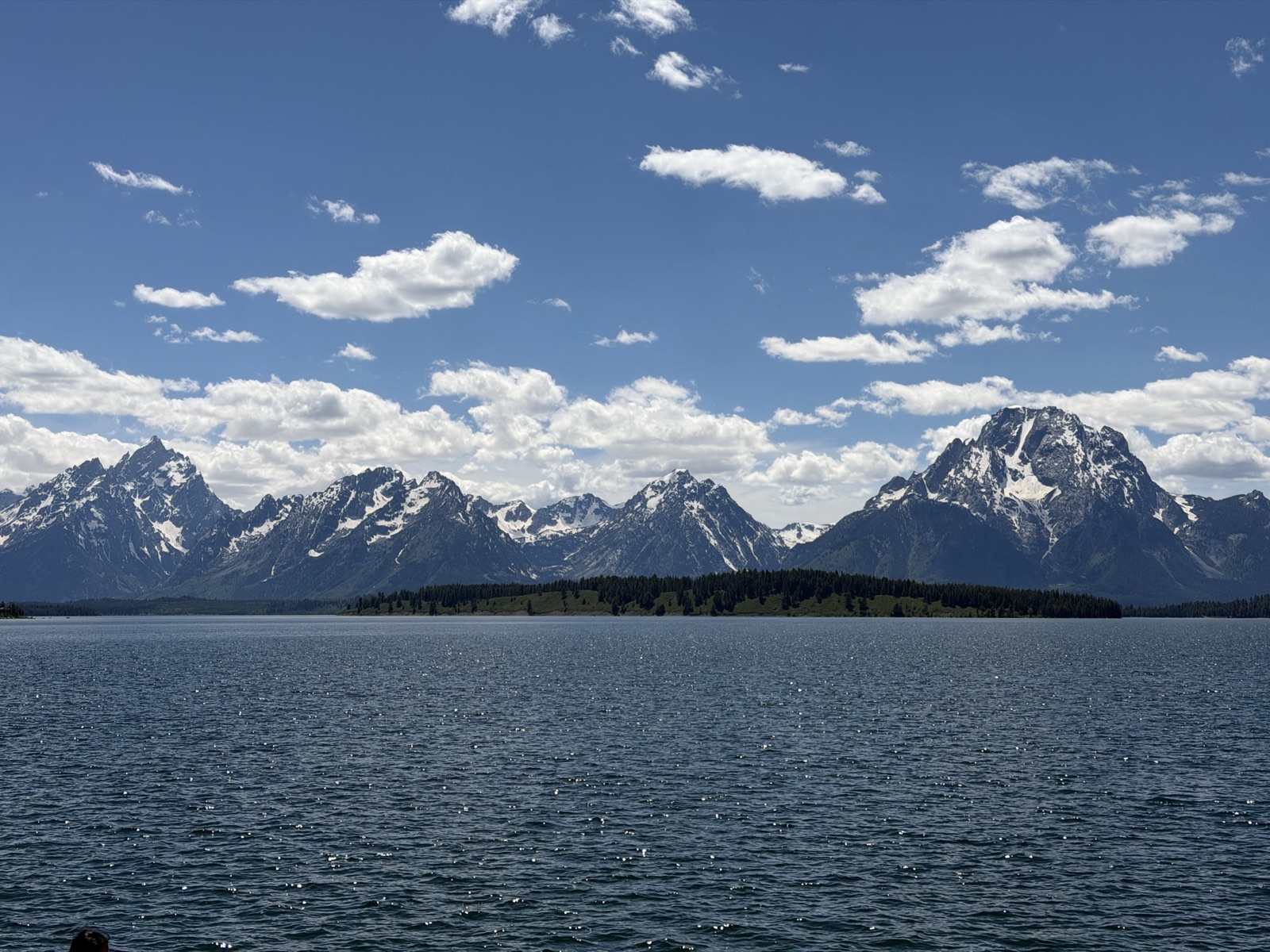 Blue lake stretching toward the snow-streaked Teton Range