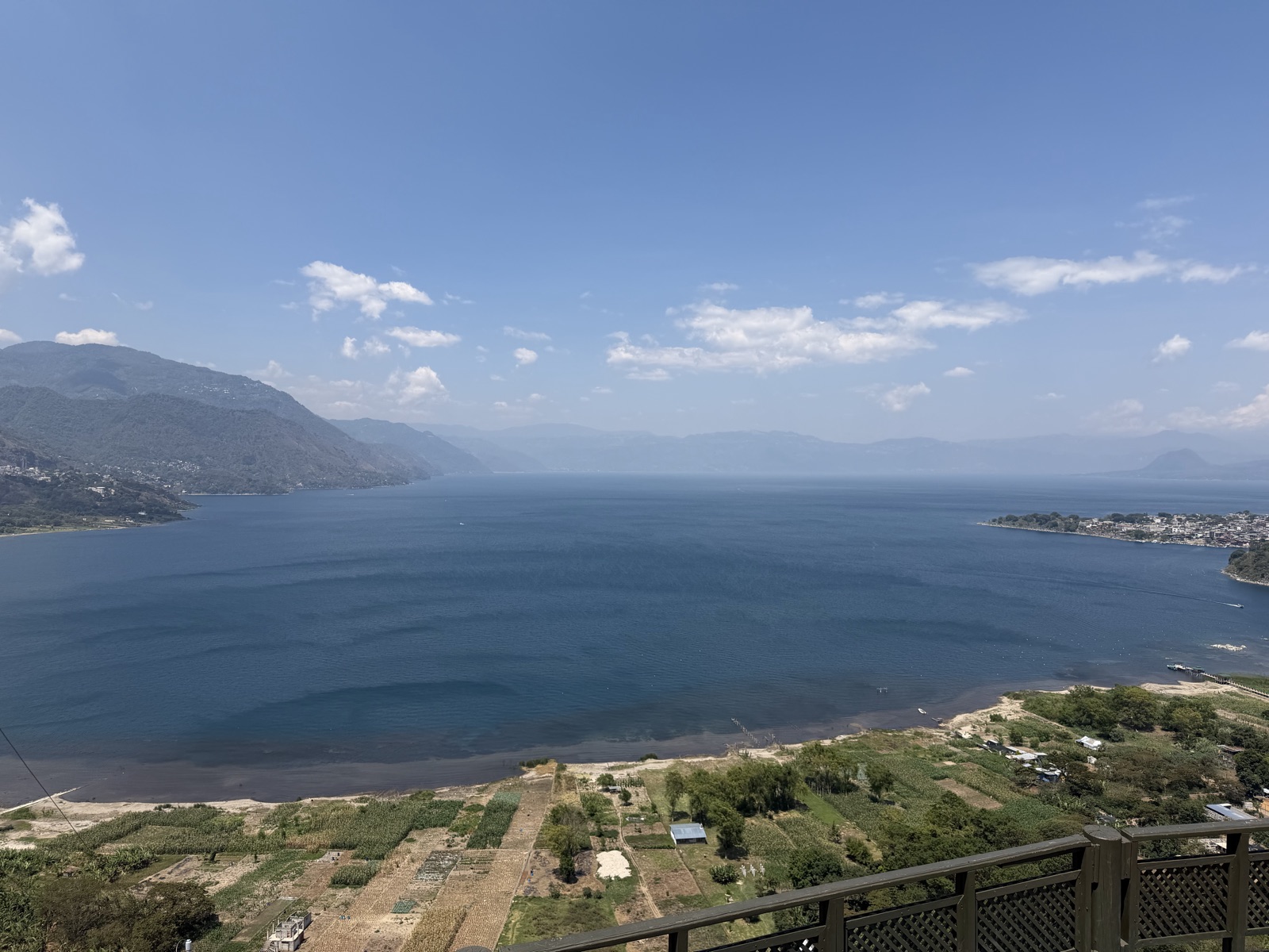 Lake Atitlan from a high overlook with farms and mountains