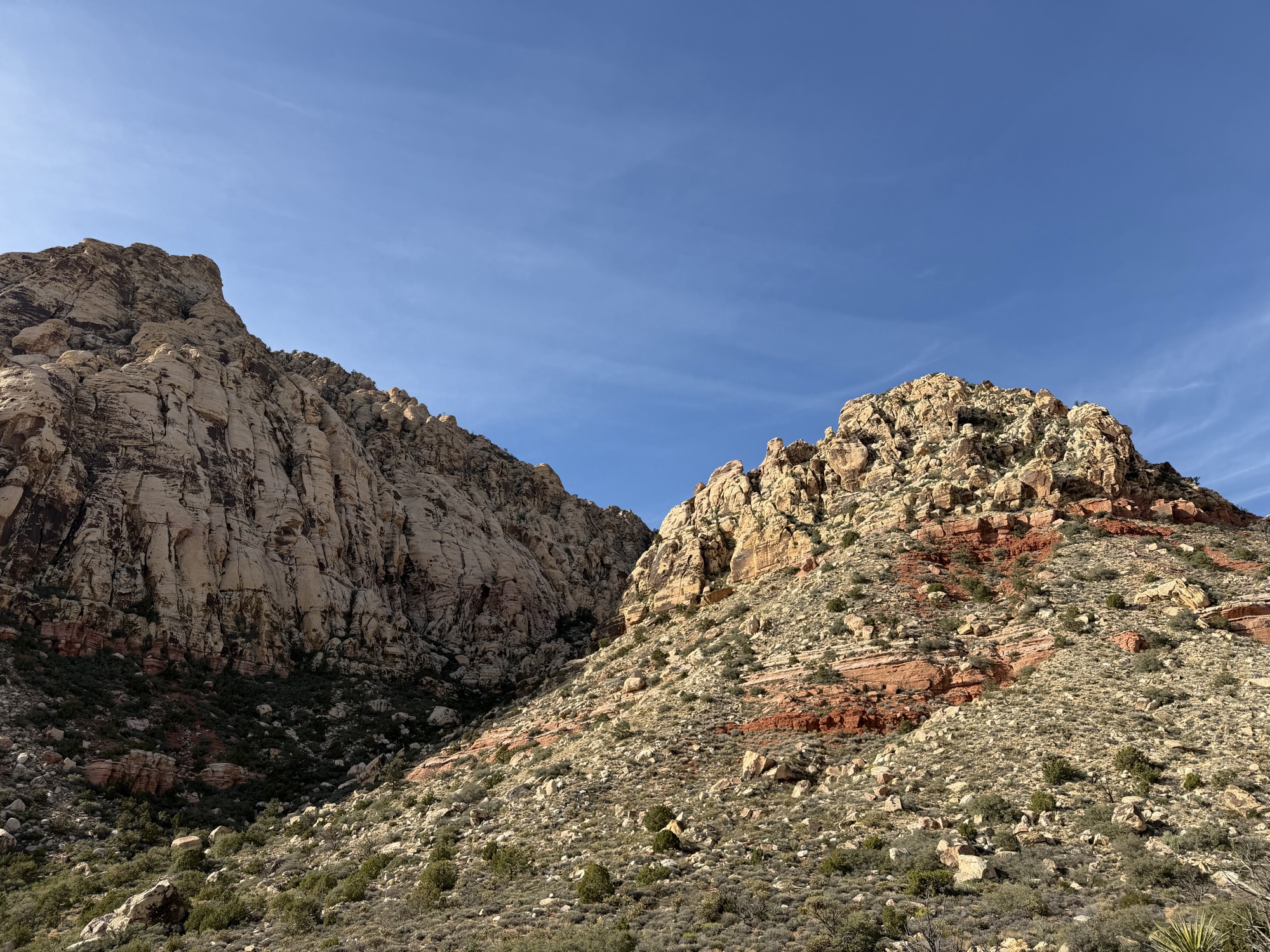 Layered sandstone cliffs under a clear blue sky at Red Rock Canyon